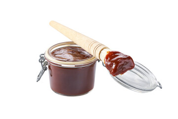Barbecue sauce in a jar with barbecue brush isolated on a white background.