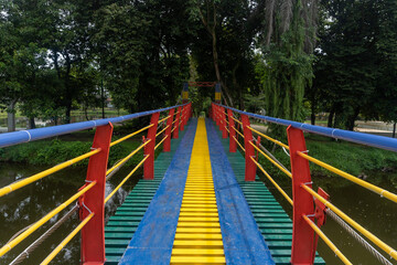 Colorful suspension bridge in the middle of a city park
