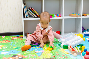 Toddler playing with wooden shapes