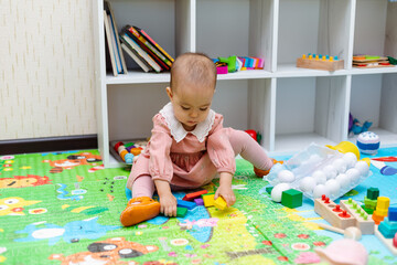 Toddler playing with wooden shapes