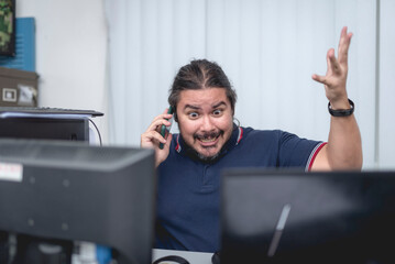 A stressed and irate man arguing over the phone with someone. Furious with an absent or...