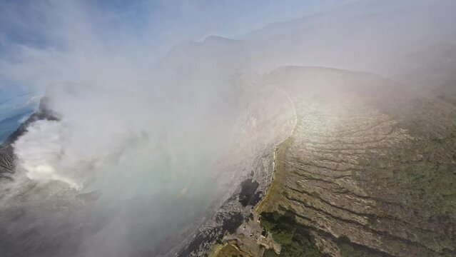 FPV sport drone dive shot tropical island volcano ridge smoke panorama stone crater mist gas steam sea landscape aerial view. Cinematic exotic scenery volcanic acid lake mountain travel environment 4k