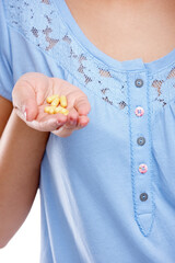 Hand, medicine and pills with a woman in studio for healthcare, prescription medication or treatment. Tablet, medical and supplements with a female holding vitamins for nutrition, health or cure