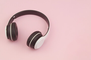 Headphones on pink background with room for text.	