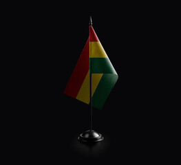 Small national flag of the Ghana on a black background