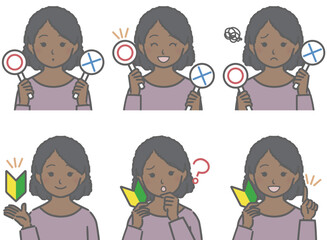 〇✕マークや初心者マークを持つ、黒人の少女