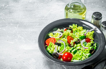 Vegetable salad. Salad of cucumbers, tomatoes and red onions with spices and olive oil.