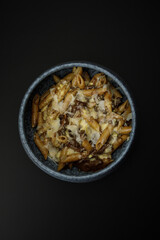 Top view of bowl with pasta with mushrooms