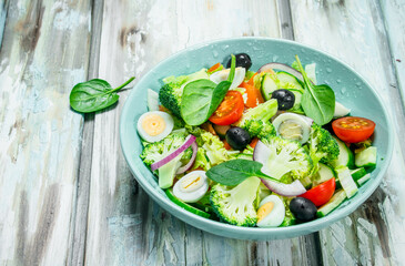 Vegetable salad. Salad of tomatoes, cucumbers and quail eggs with olive oil.