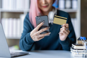 Young businesswoman using smartphone and credit card for online shopping online payment