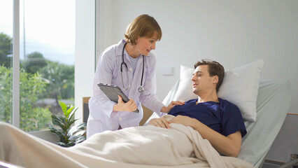 Obraz premium Portrait of caucasian doctor check up body of sick patient on bed in hospital in medical and healthcare treatment at nursing home or clinic. People lifestyle