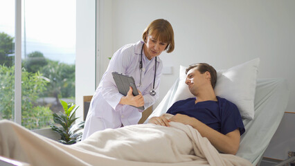 Fototapeta premium Portrait of caucasian doctor check up body of sick patient on bed in hospital in medical and healthcare treatment at nursing home or clinic. People lifestyle