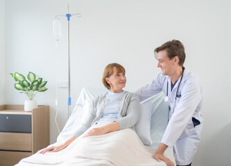 Portrait of caucasian doctor check up body of sick patient on bed in hospital in medical and healthcare treatment at nursing home or clinic. People lifestyle