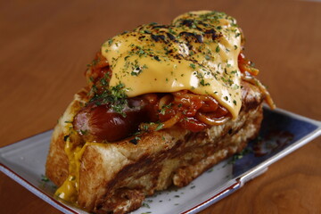 Gourmet fusion of French toast, hotdog, spaghetti and cheese
