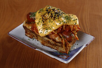 Gourmet fusion of French toast, hotdog, spaghetti and cheese