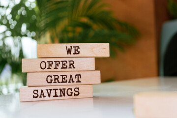 Wooden blocks with words 'We offer Great Savings'.