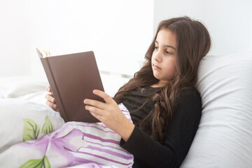 pre teen girl writing diary in bedroom
