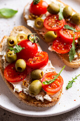 Appetizer with bruschetta with tomatoes and olives