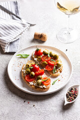 Appetizer with bruschetta with tomatoes and olives