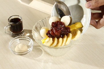 Japanese dessert of mochi balls, red bean paste, banana slices top with caramelized sugar
