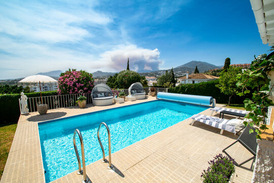 a poolside image inside a luxury chalet with Mediterranean mountain views 