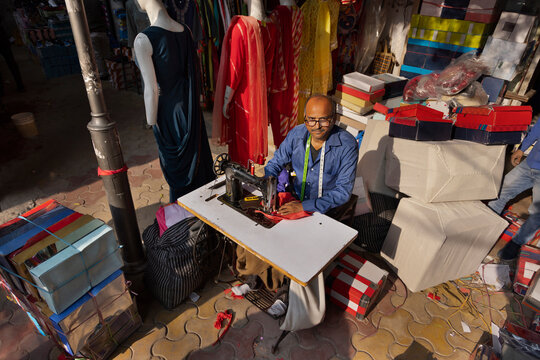 Overhead view of a tailor swing clothes in his roadside workshop