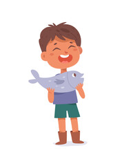 Happy boy holding fish, lucky little fisherman caught fish in water of summer river