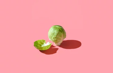Zelfklevend Fotobehang Brussels sprout isolated on a vibrant pink background. © YesPhotographers