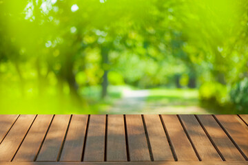 wooden table with park bokeh background