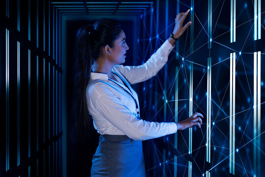 Female Technician/programmer working on the server in the data storage room