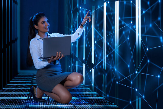 Technician/programmer holding a laptop in the server/data  room