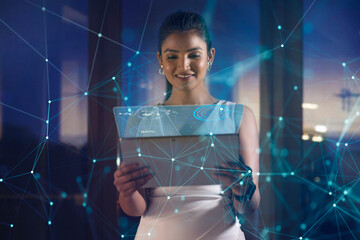 Young woman uses digital tablet on virtual visual screen at night 