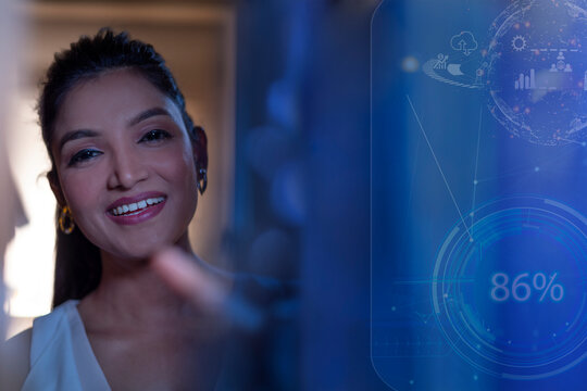 Businesswoman Smiling with icons on virtual screen