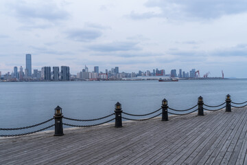 Wooden plank road on the edge of city port.