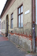 Old building with ruined wall and eaves