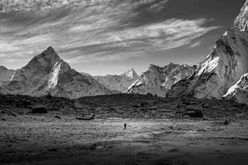 Black & white photo : A man trekking to chola pass with beautiful Ama Dablam viewpoint in the morning (EBC, Everest, Himalaya, Nepal)