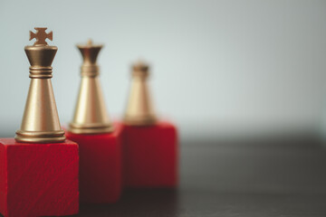 Golden king chess standing on a red wooden stand. The concept of leaders in good organizations must...