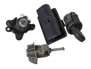 Detail of a car spare part made of black plastic and metal - keyhole lock with key for opening the trunk separately, isolated on a white background. Repair in a car workshop, equipment for sale.