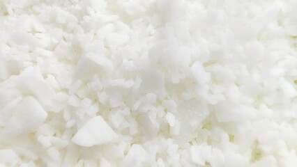 macro shot of soy wax flakes for candle making. Soy wax flakes falling
