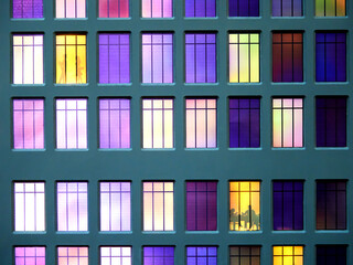 Fragment of the layout of the facade of a multi-storey building. The lights are on in the windows.