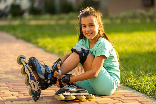 Little girl in roller skates at a park.