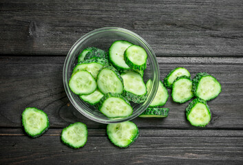 Sliced cucumbers in a glass bowl.
