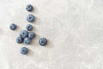 Top view of a group of fresh blueberries on gray background.