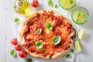 Tasty pizza Margherita made of tomatoes, basil and cheese.