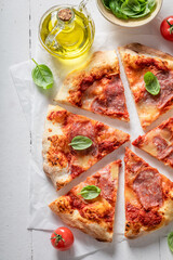 Delicious and hot pizza on wooden table. Classic Italian cuisine.