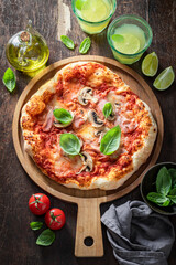 Spicy Capricciosa pizza with cheese, ham and mushrooms. Italian pizza.