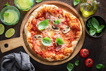 Homemade Capricciosa pizza made of ham and mushrooms.