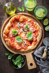 Homemade Capricciosa pizza made of fresh ingredients. Traditional Italian pizza.