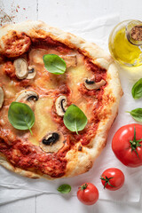Delicious and hot pizza with tomatoes, cheese and mushrooms.