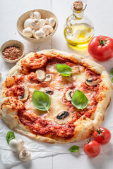 Delicious and hot pizza made of cheese and mushrooms.